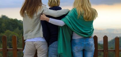 a group of three women standing next to each other