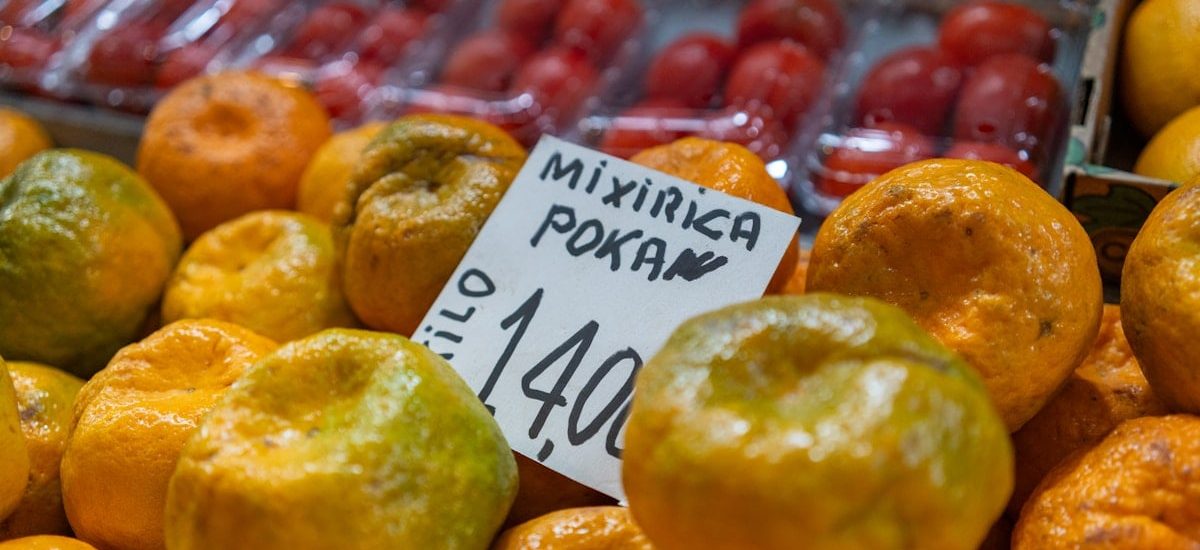 Fresh tangerines are for sale at the market.