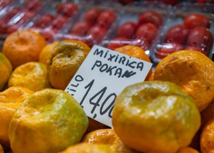 Fresh tangerines are for sale at the market.